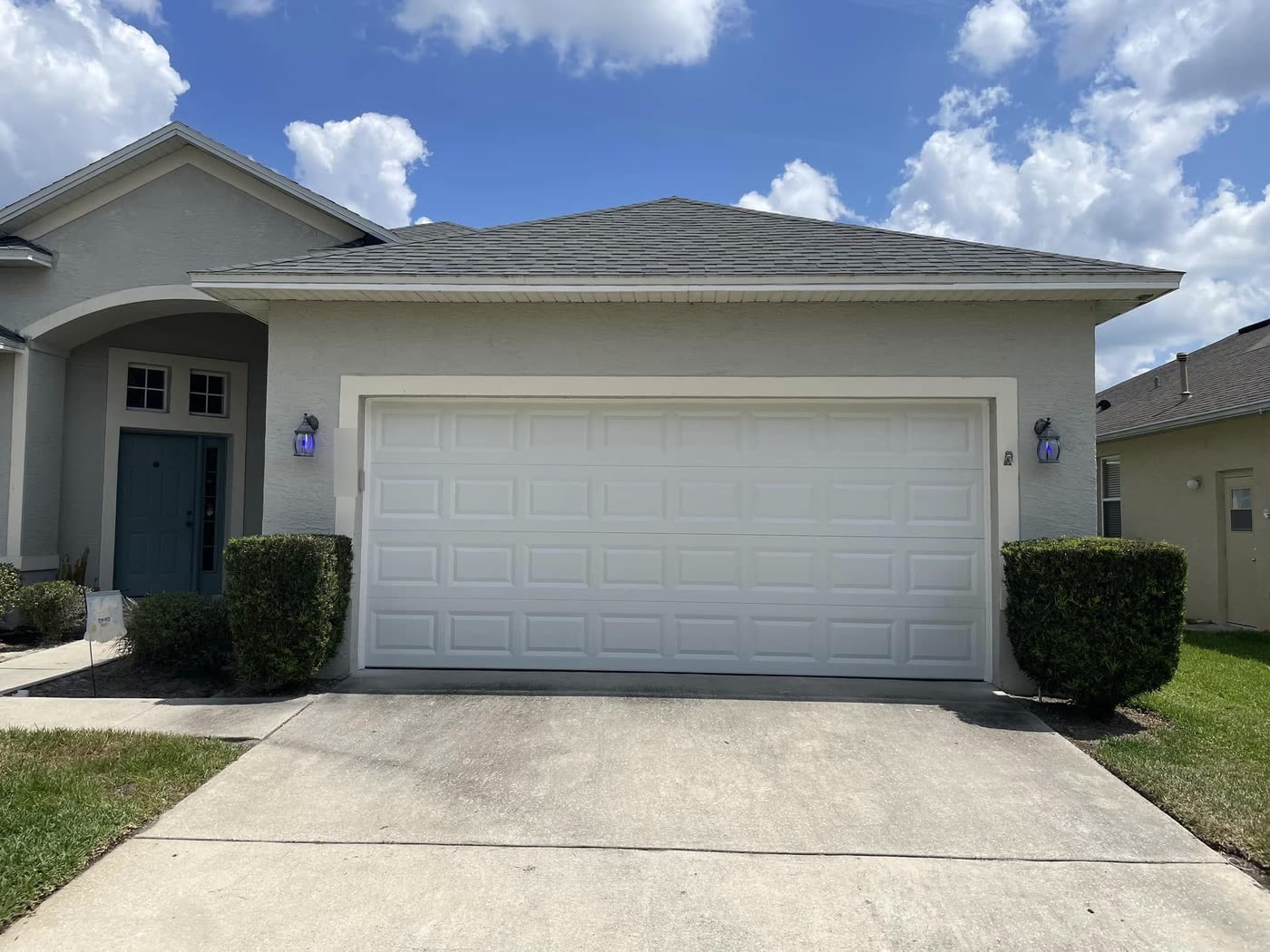 A new white insulated steel garage door