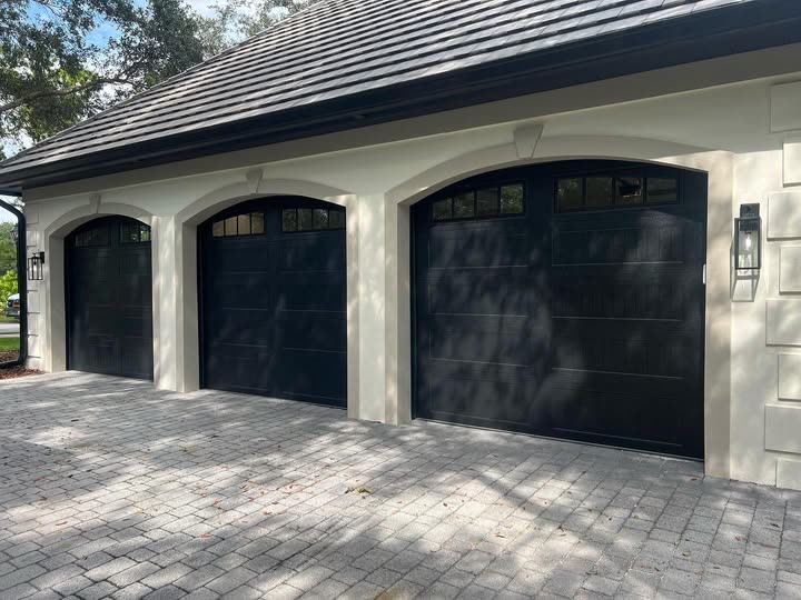 Three black carriage-style garage doors