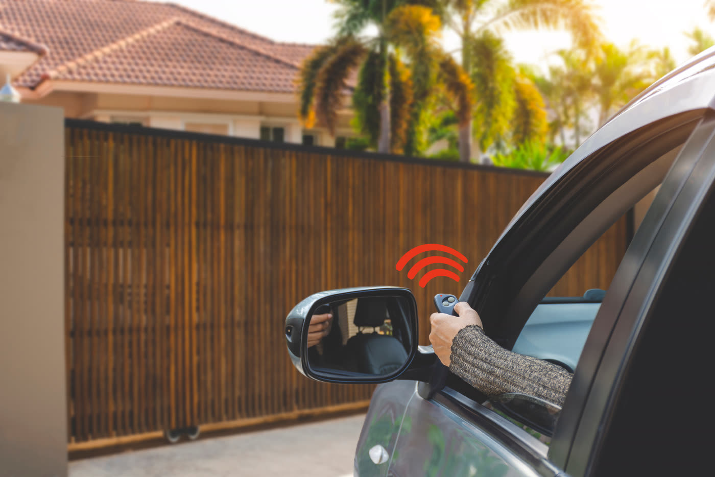 A driver operating a door remote from the car window