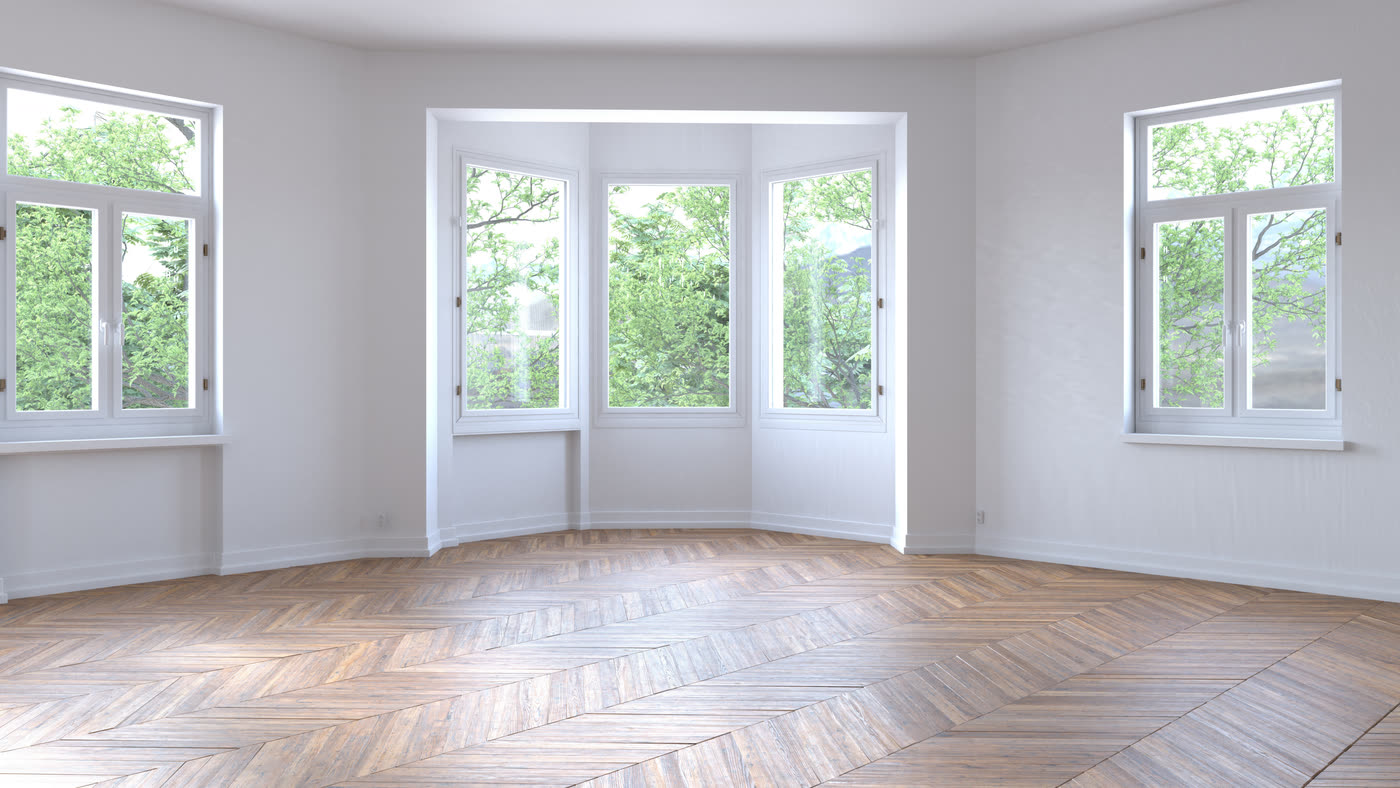 A bay window with three panels looking onto trees