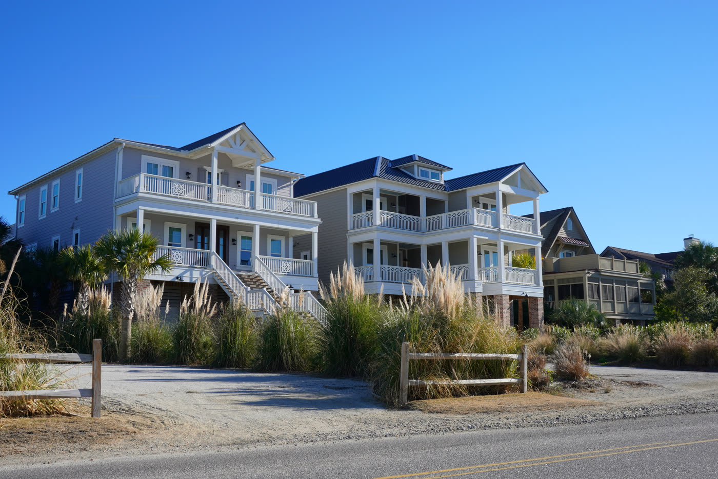 Raised coastal homes behind the dune line