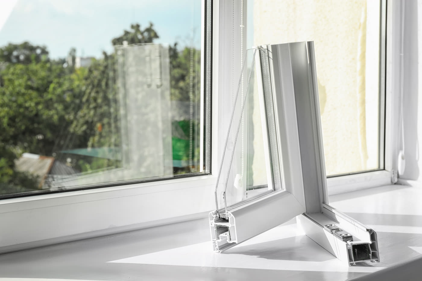 A cutaway section of a window frame showing the insulated glass and chambers