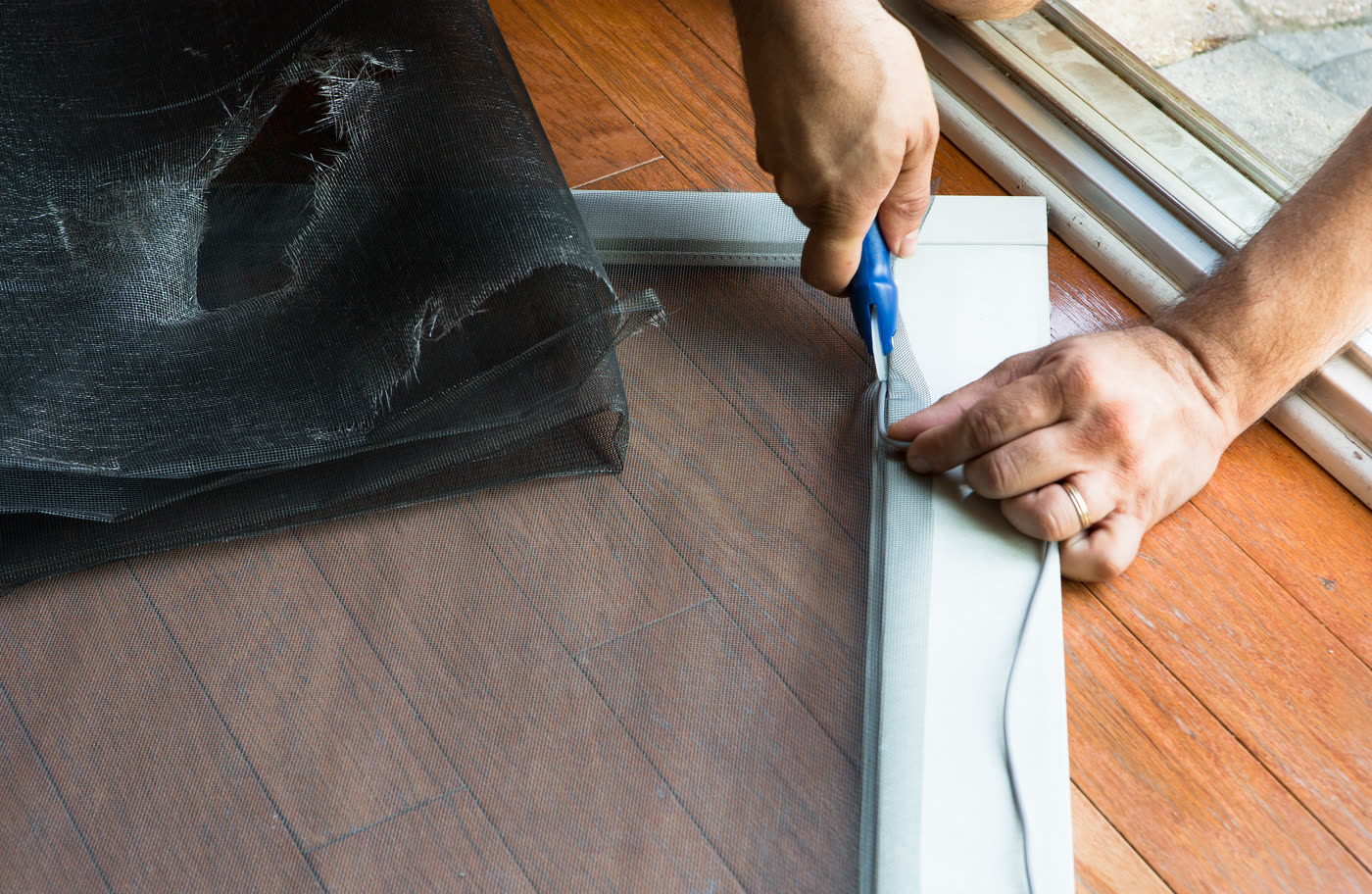 Re-screening a window screen with a spline roller