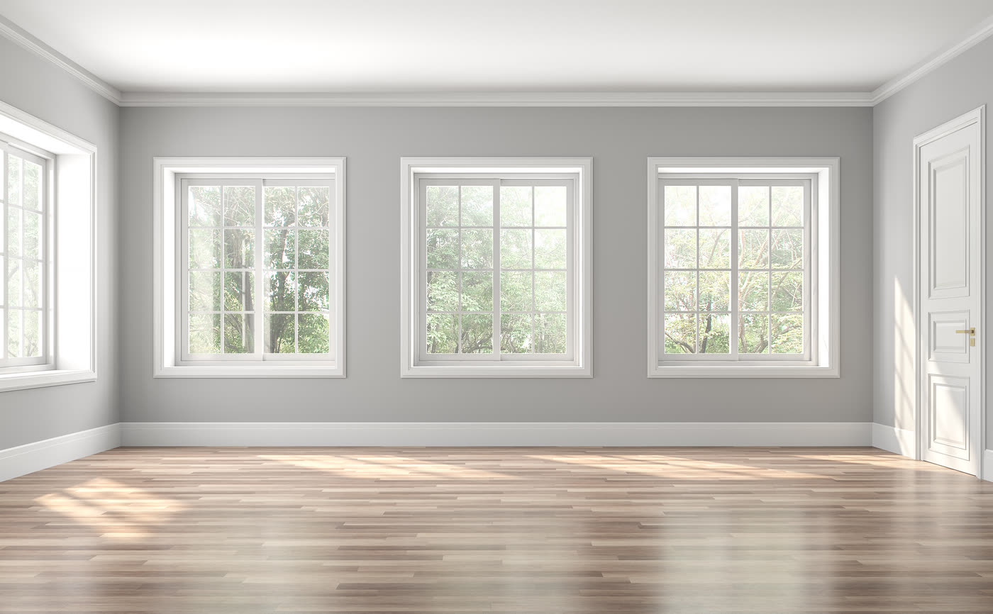 A room with three newly installed white replacement windows